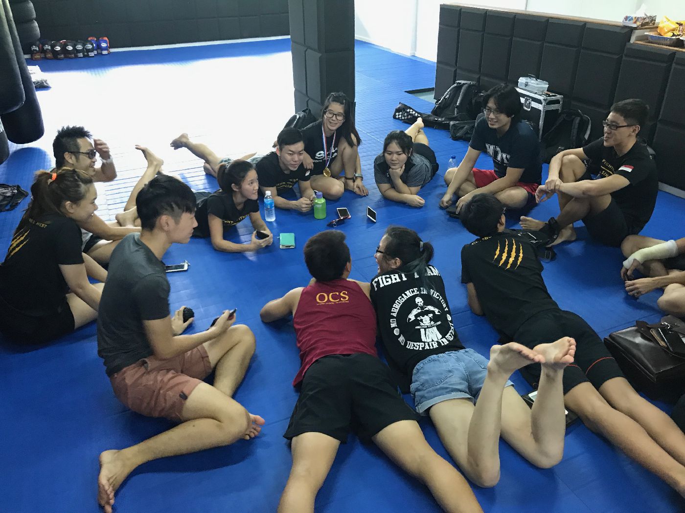 Muay Thai Singapore West students sitting down and chatting after Muay Thai lesson