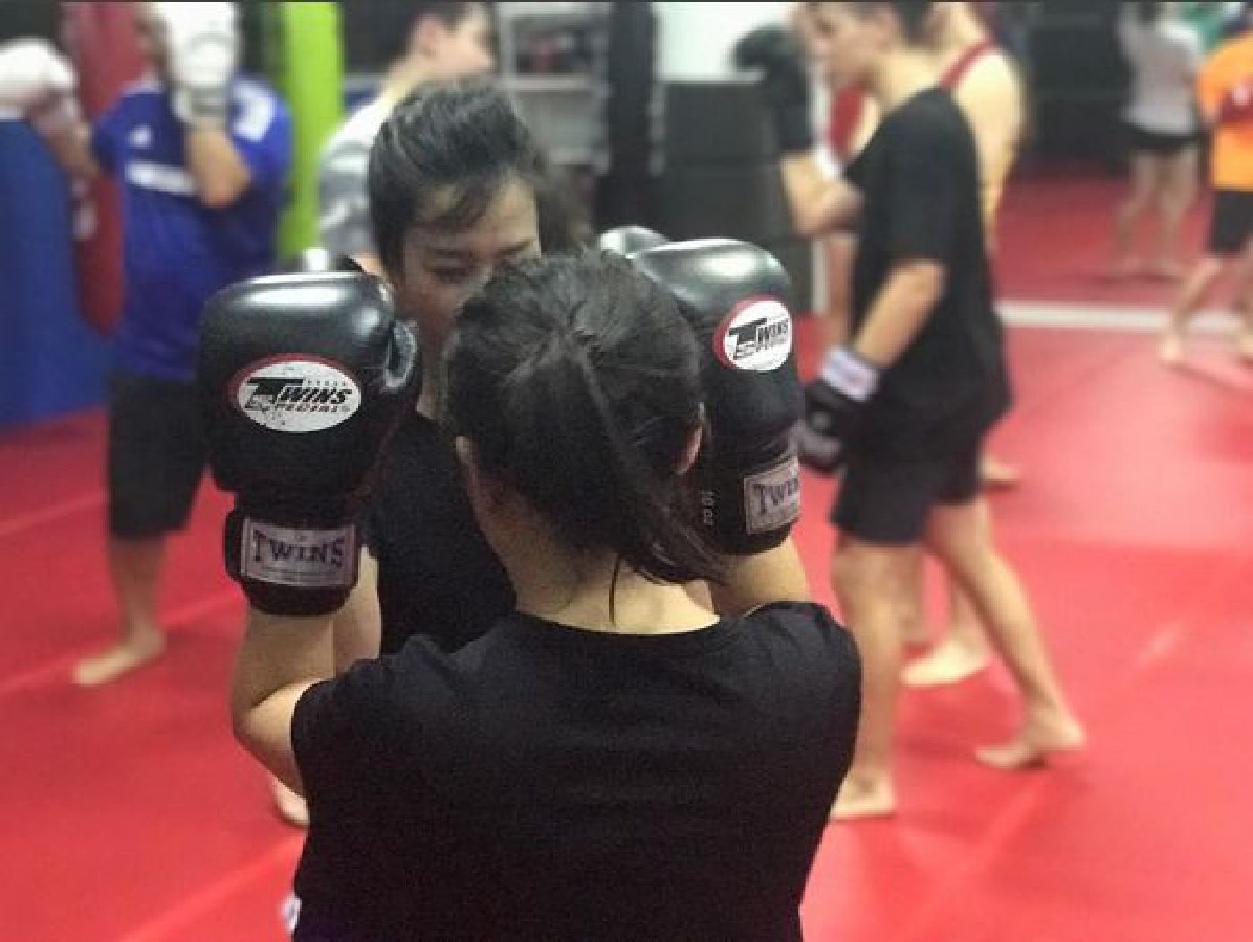 Female Muay Thai Singapore West students doing Muay Thai boxing drills