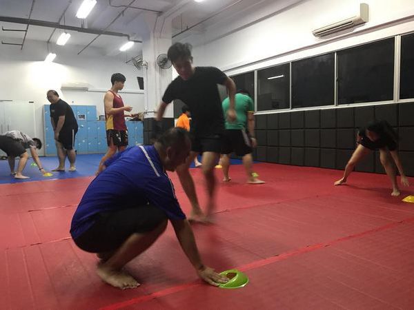 Muay Thai Singapore West students doing speed cone drills to improve conditioning