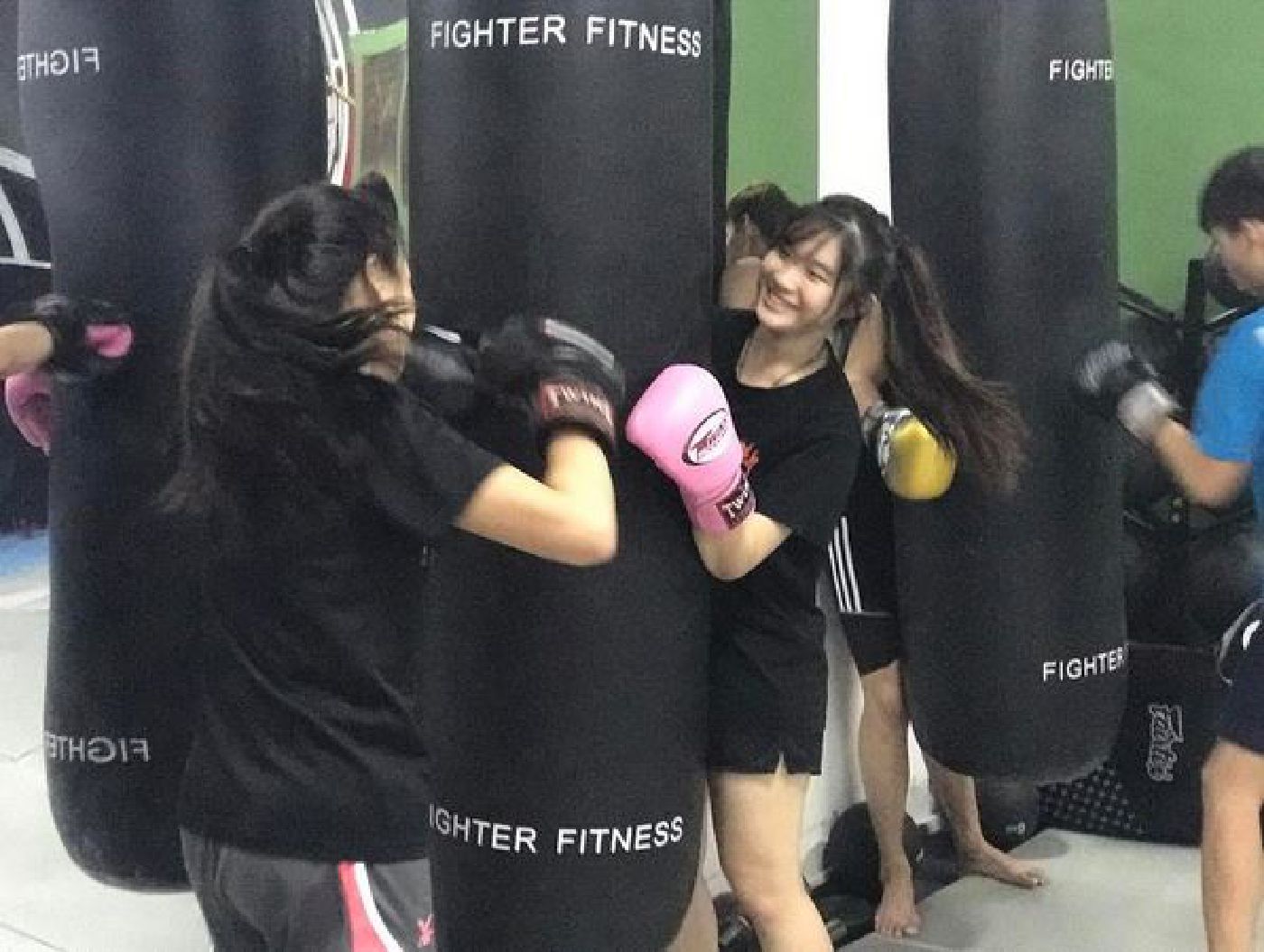 Muay Thai Singapore West students having fun doing bagwork together